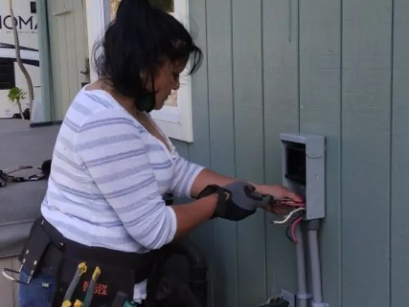 Licensed electrician wiring an exterior subpanel in Portales